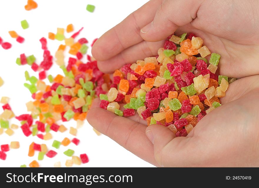 Sweet colorful candied fruits in the hands of