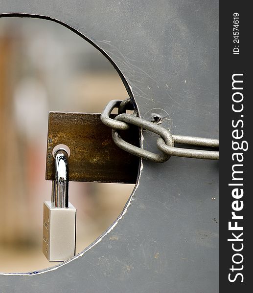 Security padlock and chain on a construction's site door. Security padlock and chain on a construction's site door.