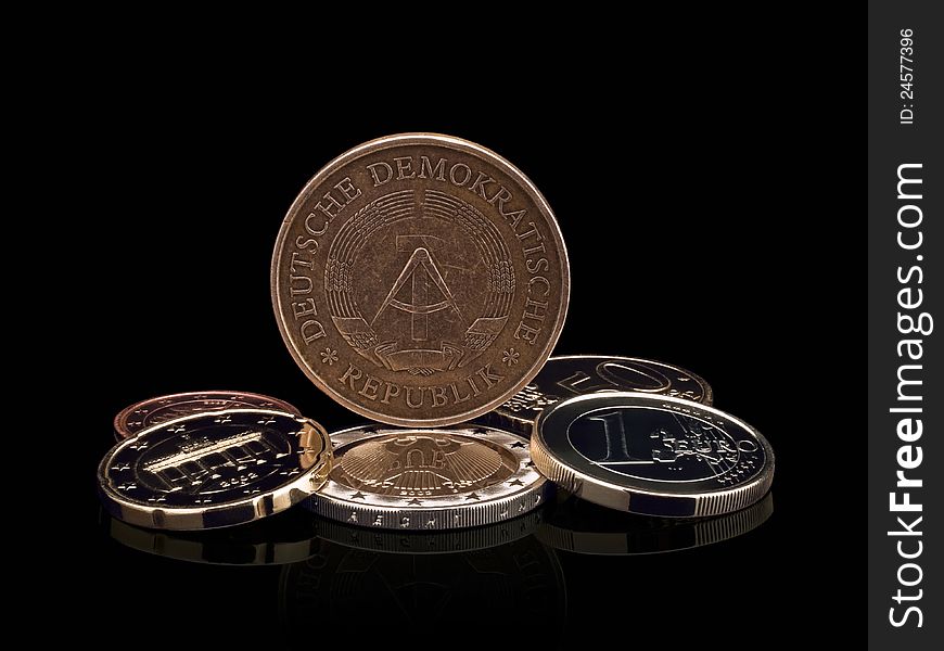 Coins of GDR (DDR) and the European union on a black background. Coins of GDR (DDR) and the European union on a black background.