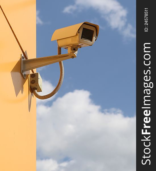 Surveillance camera against sky background