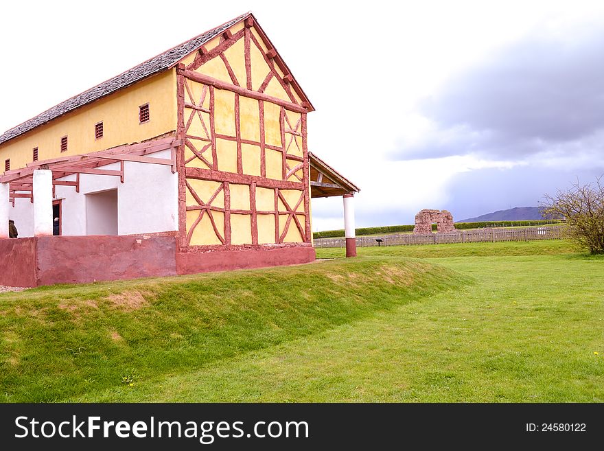 The modern replica of an ancient Roman Villa stands before the ancient ruins of the roman town in Wroxeter. The modern replica of an ancient Roman Villa stands before the ancient ruins of the roman town in Wroxeter.