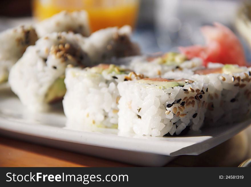 Tasty sushi - california rolls on white plate