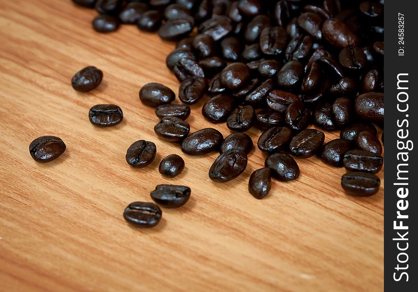 Roasted coffee  beans  on wood texture. Roasted coffee  beans  on wood texture.