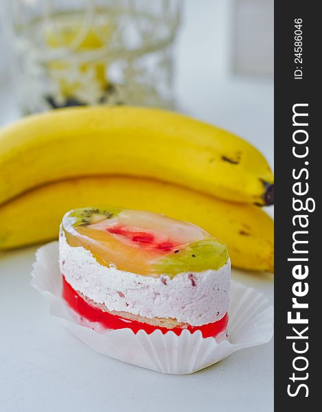 Fruitcake and bananas on a white table