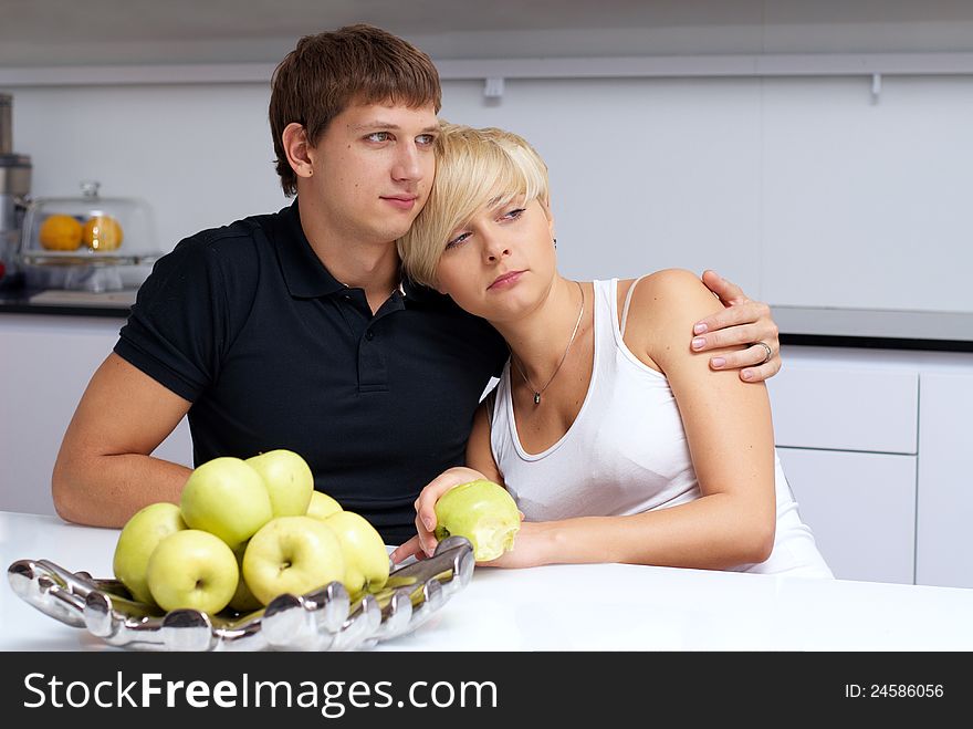 Portrait of a happy couple posing in the kitchen