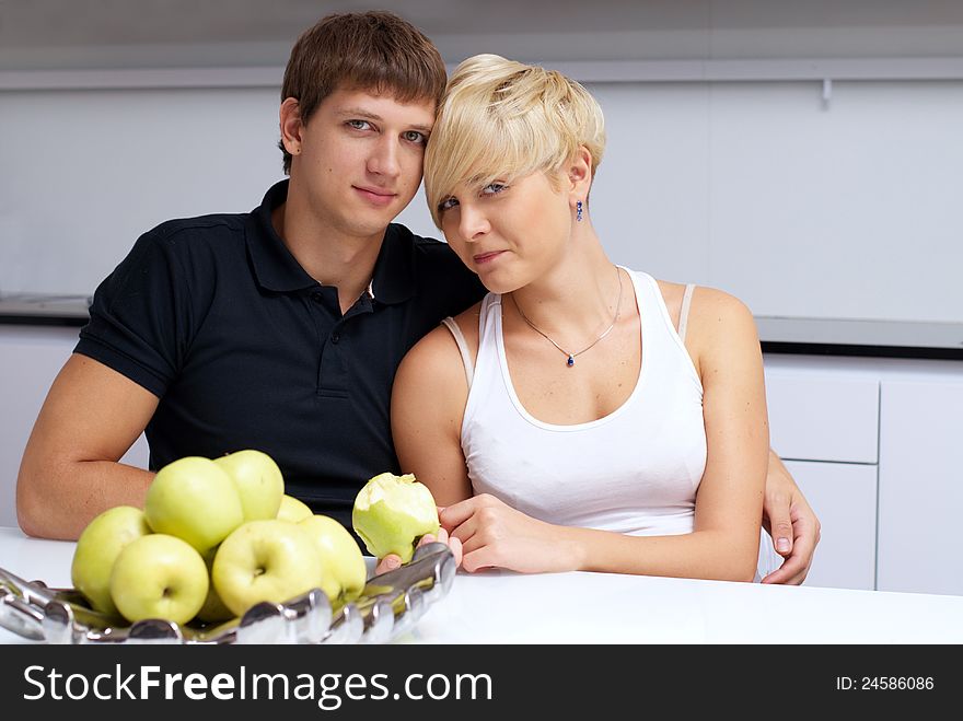 Portrait of a happy couple posing in the kitchen