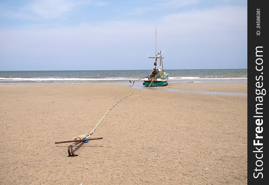 A fishing boat anchored by the beach
