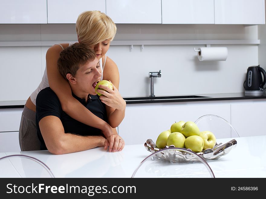 Portrait of a happy couple posing in the kitchen