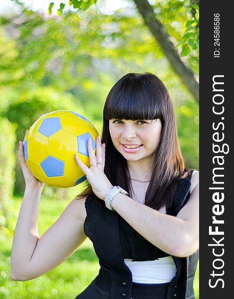 Beautiful Ukrainian girl with a ball in the colors of national flag inviting to Euro 2012