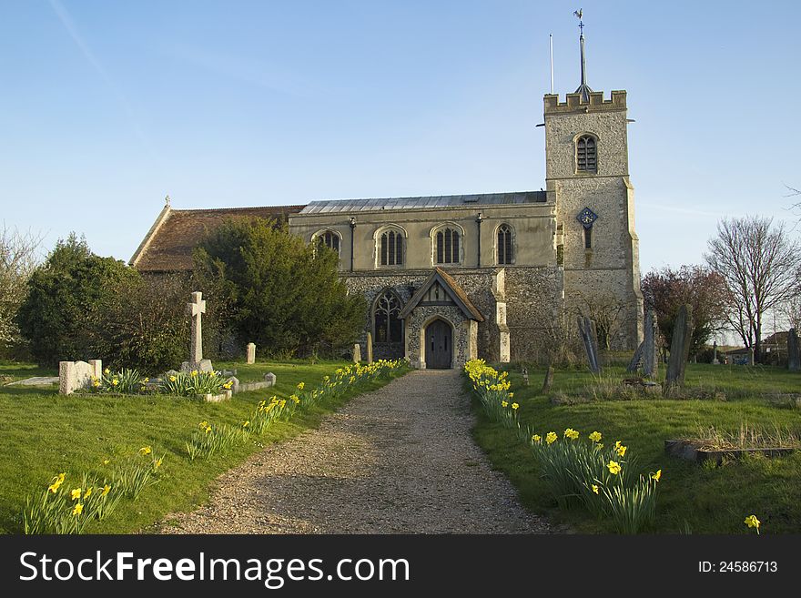 Typical church and grounds in English village in late evening sunshine. Typical church and grounds in English village in late evening sunshine