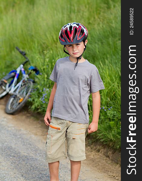 Portrait of small boy bicyclist with helmet