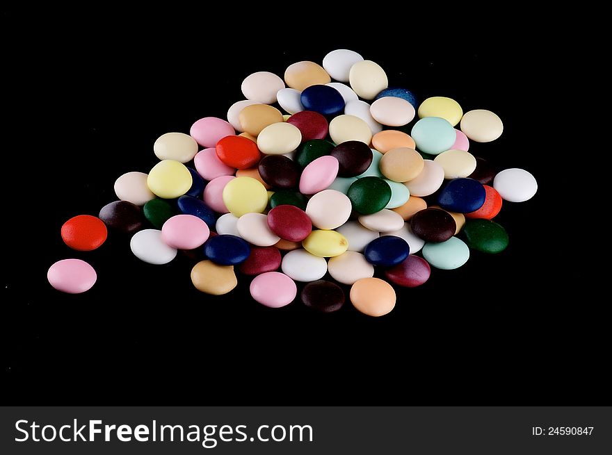 Multicolored Chocolate Dragee Sugarcoated isolated on black backround. Multicolored Chocolate Dragee Sugarcoated isolated on black backround