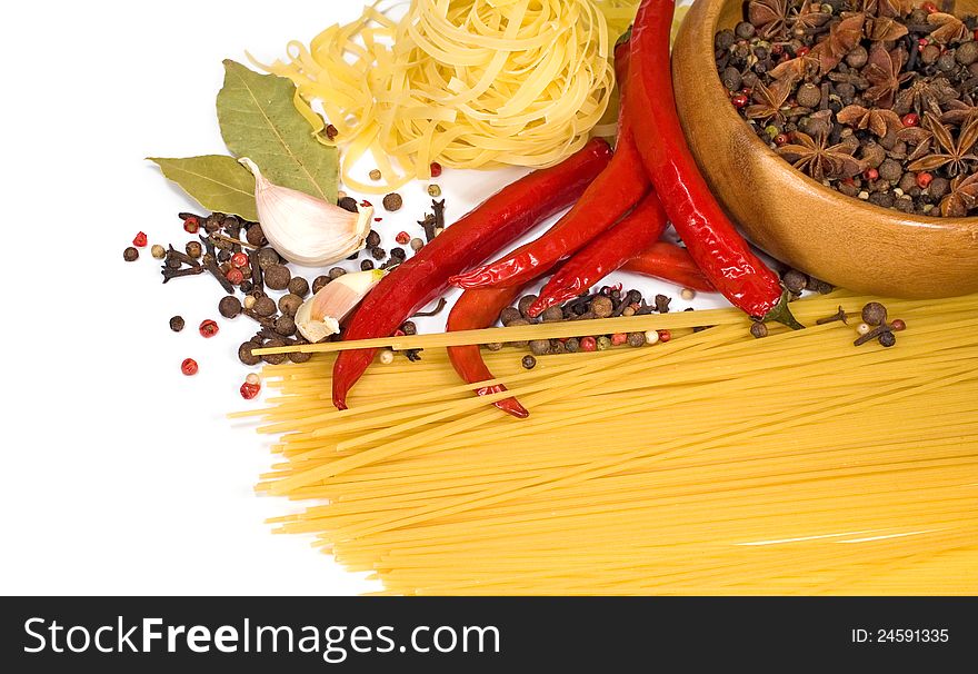 Food: spaghetti, spices and peppers on a white background