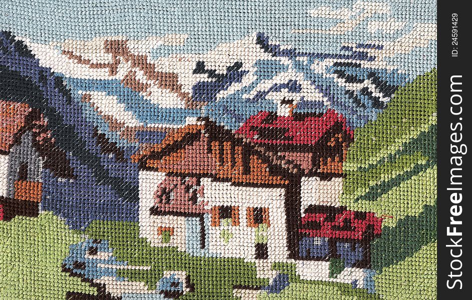 Handmade embroidery ,mountain landscape with chalets. Handmade embroidery ,mountain landscape with chalets.