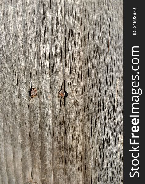 Image of a wood plank with two nails. Image of a wood plank with two nails