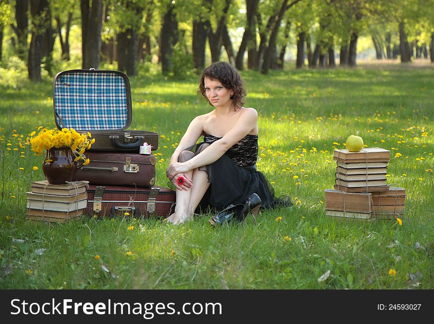 Romantic girl dreaming of books around in the park