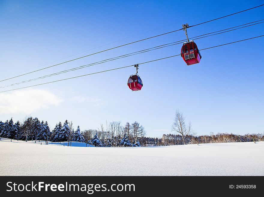 Two red cable car in winter