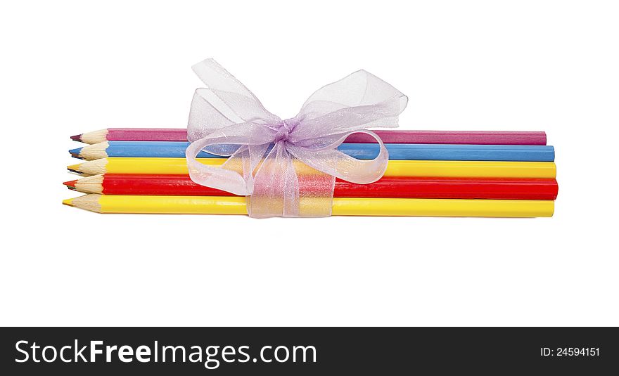 Crayons tied with lilac ribbon on white background. Crayons tied with lilac ribbon on white background