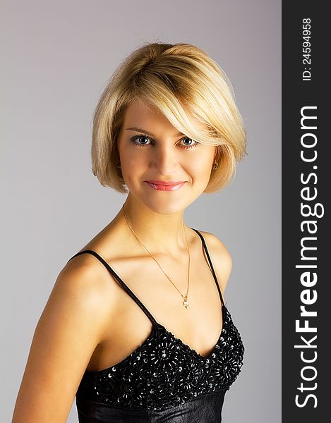 Portrait of young pretty girl posing in studio on light background