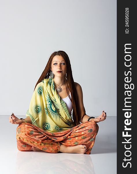 Young indian woman posing sitting on the floor in studio