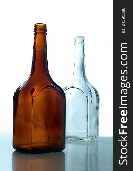 Two empty bottles standing on a white background