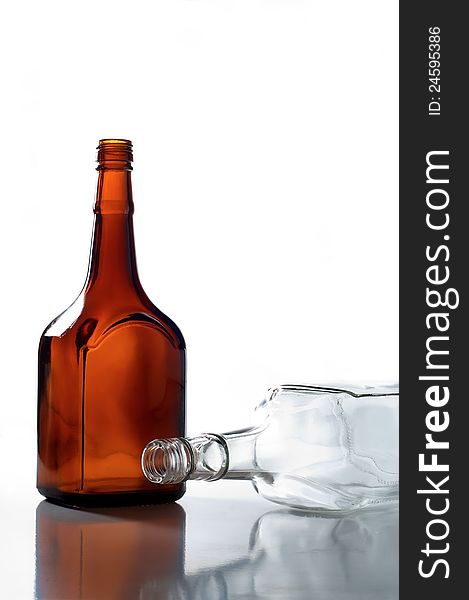 Two empty bottles standing on a white background