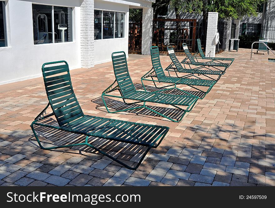 Green pool chairs in line