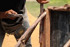 Hands Of Man Working In Construction Site Nailing In The Wood With A Hammer. Stock Images