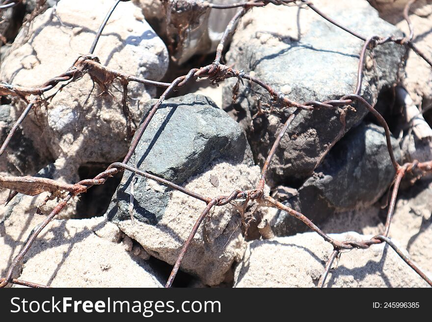 iron rusty net on the rocks