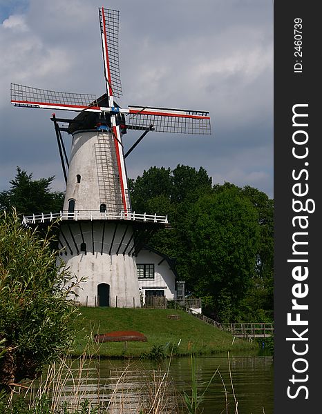 White dutch windmill at the shore of the river Linge. White dutch windmill at the shore of the river Linge