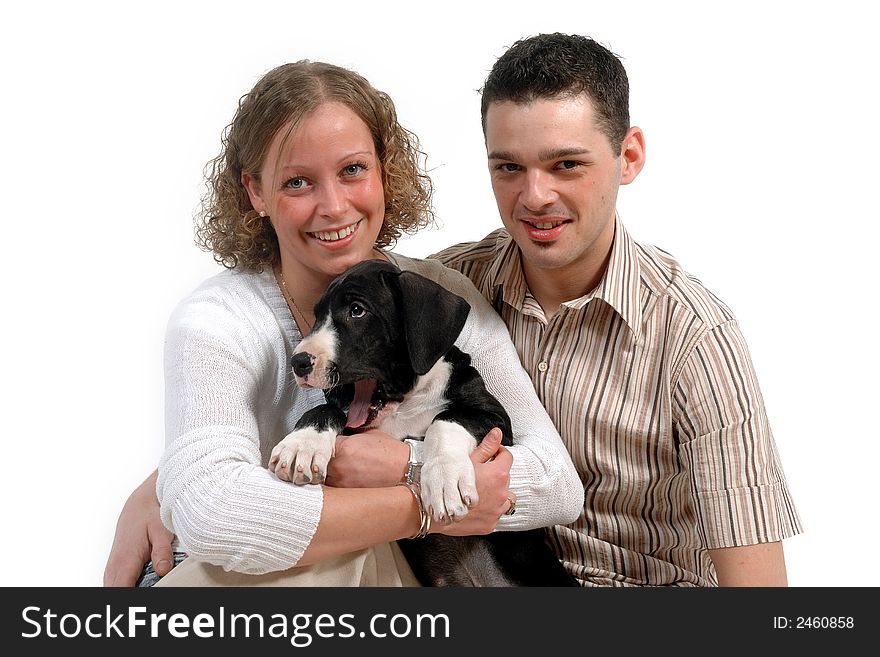 Portrait of a young happy couple and their sweet puppy. Portrait of a young happy couple and their sweet puppy.