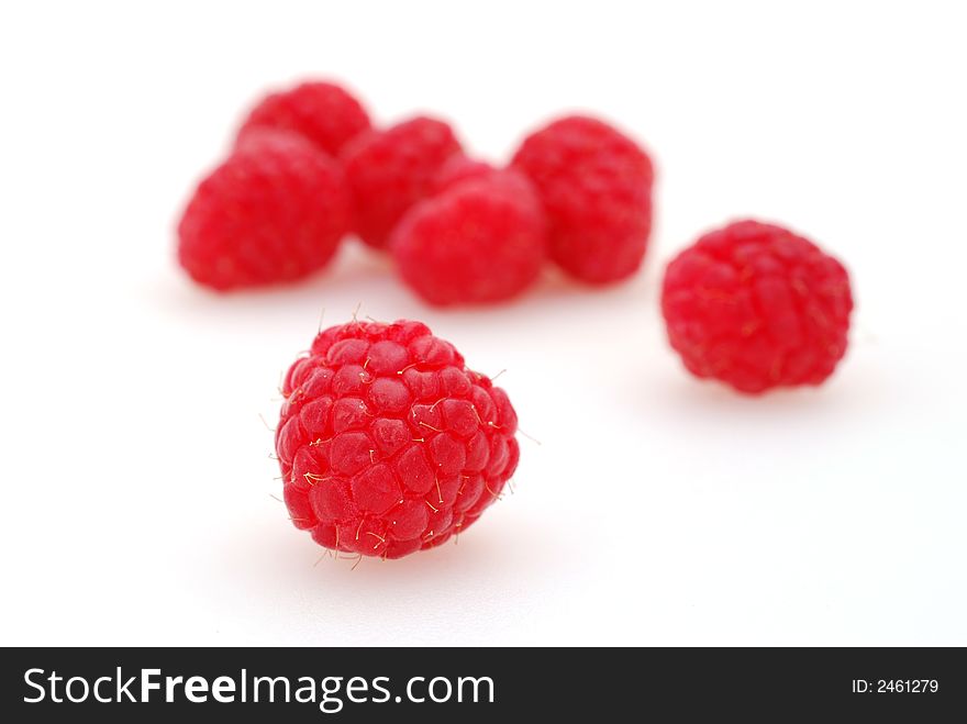 A plump and delicious raspberry shot against a white background. A plump and delicious raspberry shot against a white background