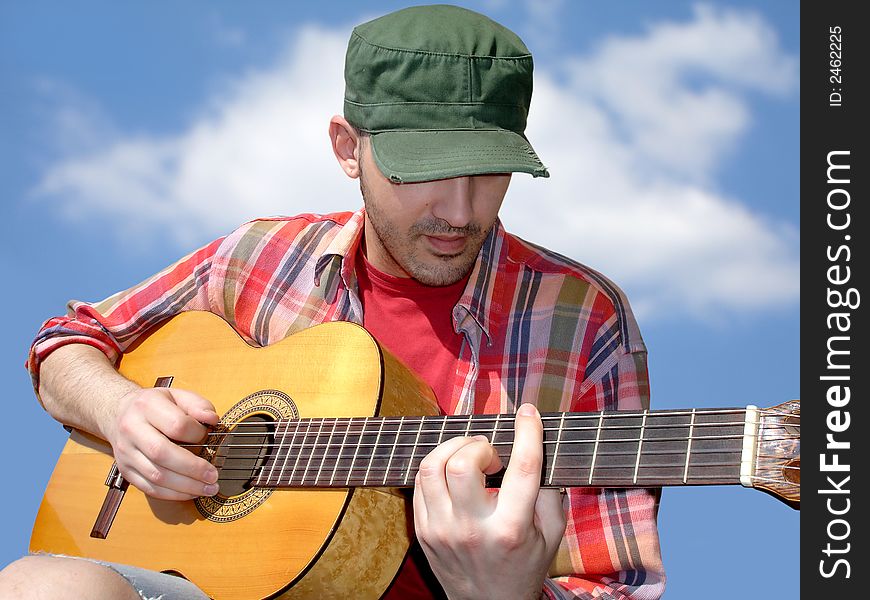 Young man playing acoustic guitar . Young man playing acoustic guitar