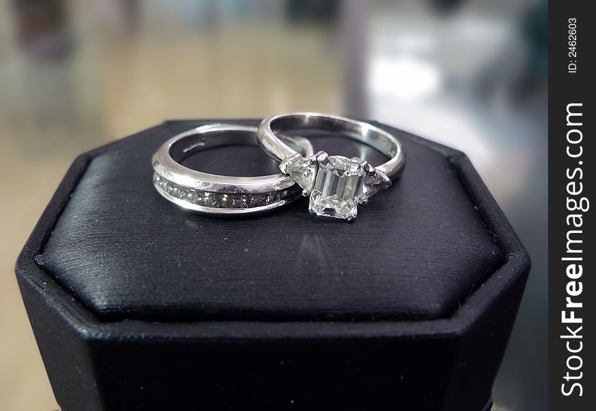 Photo of a diamond & platinum wedding ring on top of its case. Photo of a diamond & platinum wedding ring on top of its case