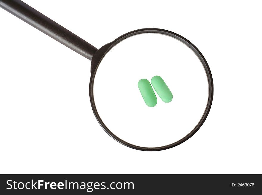 Two green pills through the magnifying glass