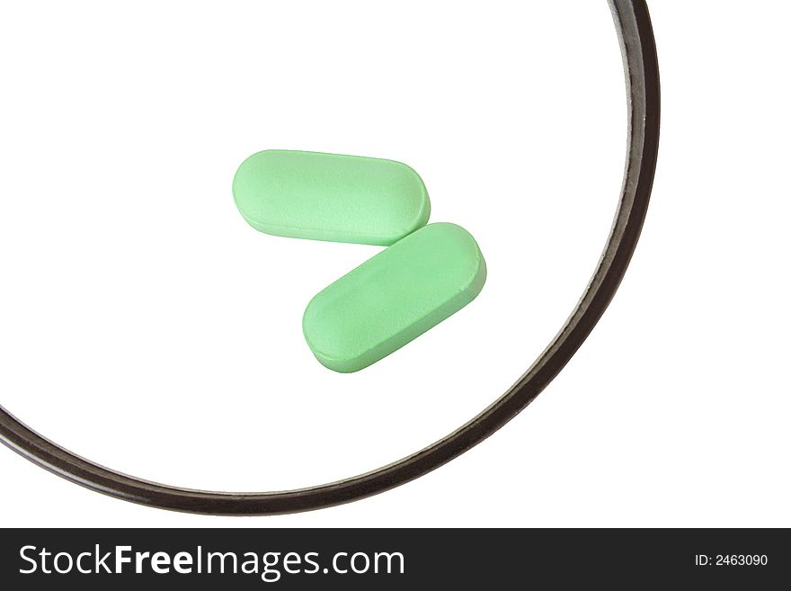 Close up of two green pills