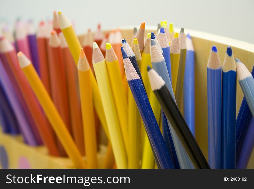 Coloured Pencils in a pencil holder at school