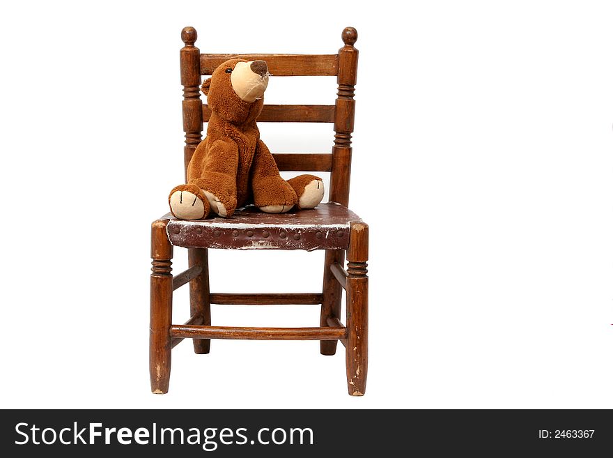 Old chair with a leather seat and a teddy. Old chair with a leather seat and a teddy