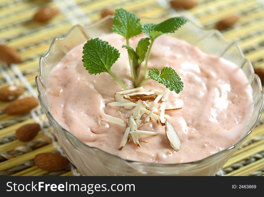 Almond cream with caramel in the glass bowl