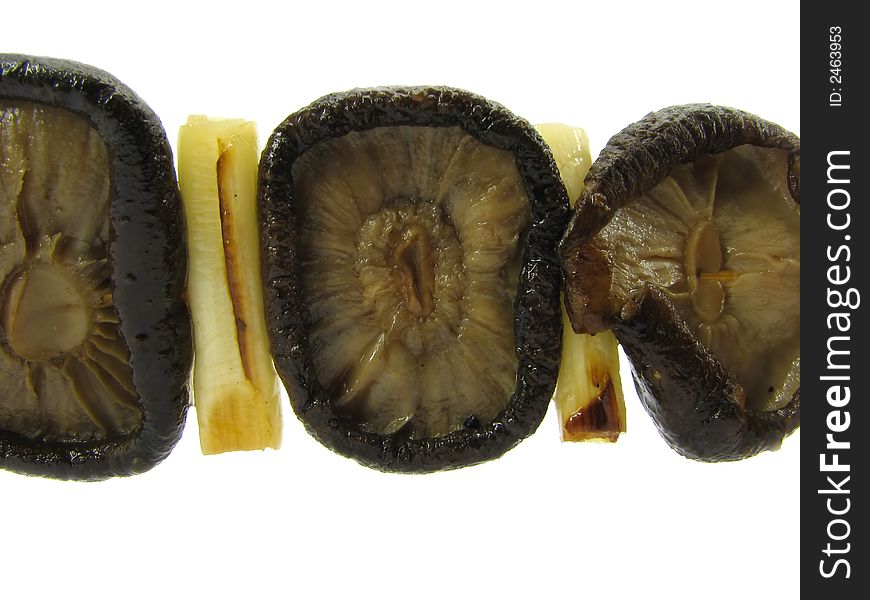 Mushrooms of a barbecue with slices of the onion, isolated on a white background. Mushrooms of a barbecue with slices of the onion, isolated on a white background.