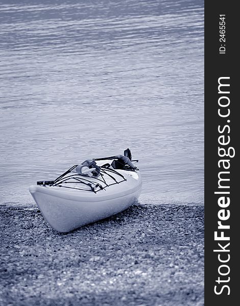 Lone kayak on the shoreside at the beach. Lone kayak on the shoreside at the beach.