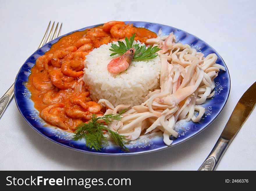 Dish from popular sea food, stewed shrims and boiled squids with rice. It's healthy and dietetical food. Dish from popular sea food, stewed shrims and boiled squids with rice. It's healthy and dietetical food.