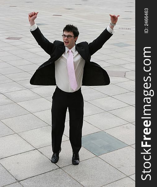 Attractive young businessman jumps for joy. Attractive young businessman jumps for joy.