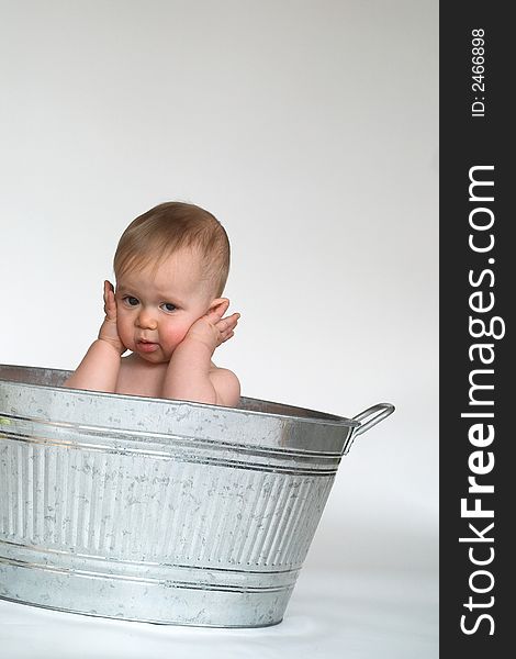 Image of cute baby sitting in a galvanized tub. Image of cute baby sitting in a galvanized tub