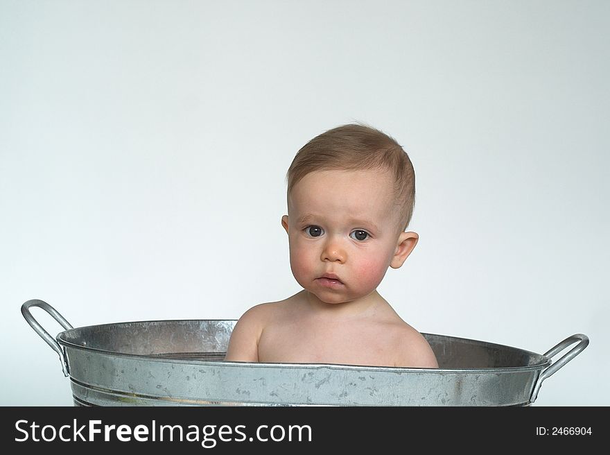 Image of cute baby sitting in a galvanized tub. Image of cute baby sitting in a galvanized tub