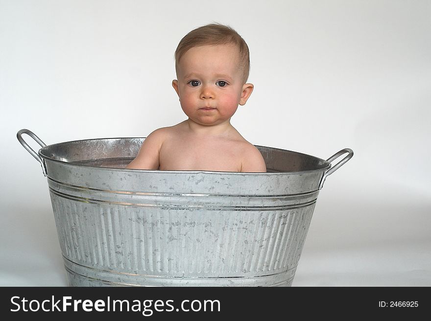 Image of cute baby sitting in a galvanized tub. Image of cute baby sitting in a galvanized tub