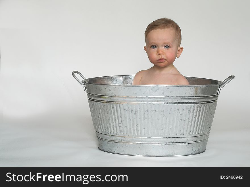 Image of cute baby sitting in a galvanized tub. Image of cute baby sitting in a galvanized tub