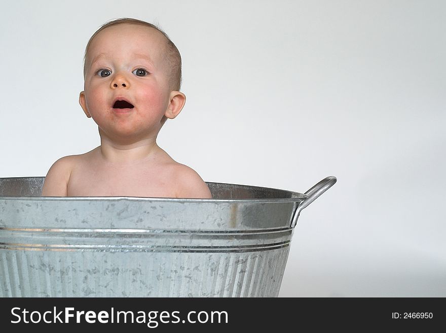 Image of cute baby sitting in a galvanized tub. Image of cute baby sitting in a galvanized tub
