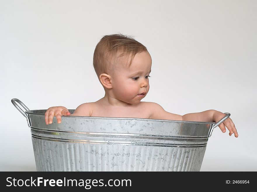 Image of cute baby sitting in a galvanized tub. Image of cute baby sitting in a galvanized tub