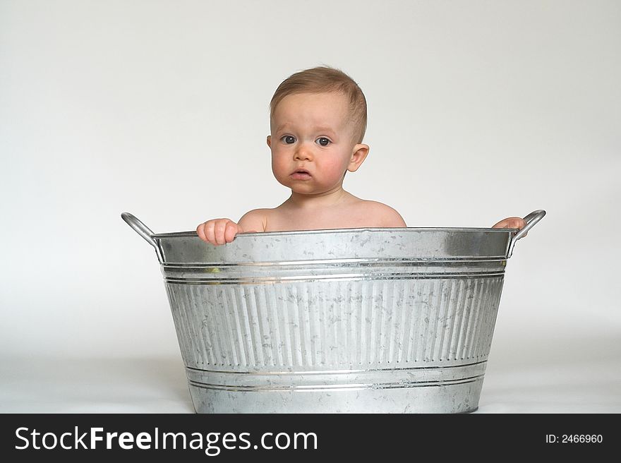 Image of cute baby sitting in a galvanized tub. Image of cute baby sitting in a galvanized tub